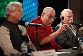 His Holiness the Dalai Lama answers questions during a press conference flanked by Professor Muhammed Yunus (L) and former Polish President Lech Walesa (R) at the 12th World Summit of Nobel Peace Laureates held in Chicago, Illinois, on April 25, 2012. Photo/Getty Images