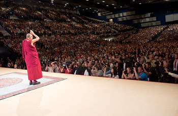 His Holiness the Dalai Lama greeting the audience at the Vienna Stadthalle before his talk "Beyond Religion - Ethics for the Whole World" in Vienna, Austria, on May 25, 2012. Photo/Tenzin Choejor/OHHDL. 