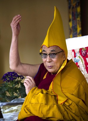 Tibetan spiritual leader the Dalai Lama wears a ceremonial yellow hat as he gives a religious talk on the 15th day of the Tibetan New Year in Dharmsala, India, Thursday, March 8, 2012 (Ashwini Bhatia – AP) 