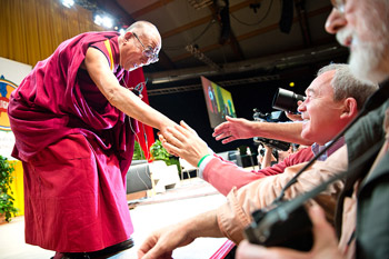His Holiness the Dalai Lama shaking hands with members of the audience before his address in Salzburg, Austria, on May 21, 2012. Photo/Tenzin Choejor/OHHDL