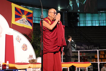 His Holiness the Dalai Lama greeting the audience on his arrival for his talk at the Palasport Primo Carnera in Udine, Italy, on May 23, 2012. Photo/Jeremy Russell/OHHDL