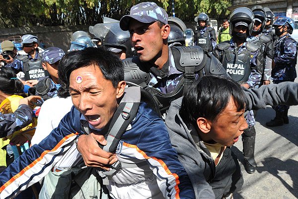 Nepalese riot police arrest Tibetan protesters in front of the consular section of the Chinese Embassy during a protest marking the 53rd anniversary of the 1959 Tibetan uprising against Chinese rule in Kathmandu on March 10, 2012/Prakash Mathema / AFP / Getty Images 