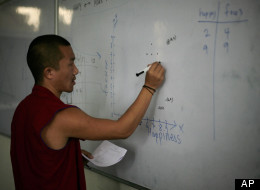 In this June 7, 2012 photo, a Tibetan Buddhist monk tries to solve a mathematical problem on a white board during a class at an educational complex in Sarah, India. Pushed by the Dalai Lama, who has became a fierce proponent of modern schooling, a series of programs were created in exile to teach scientific education to monks, the traditional core of Tibetan culture. (AP Photo/Altaf Qadri) 