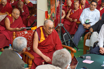 His Holiness the Dalai Lama listening to a presentation by Thupten Jinpa during the second day of the Mind and Life XXVI conference held at Drepung Monastery in Mundgod, India, on January 18, 2013. Photo/Jeremy Russell/OHHDL