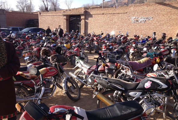 Motorbikes outside a prayer meeting in a Tibetan village in China, where thousands of Tibetans are praying for the souls of those who have self-immolated in protest over Chinese rule. 