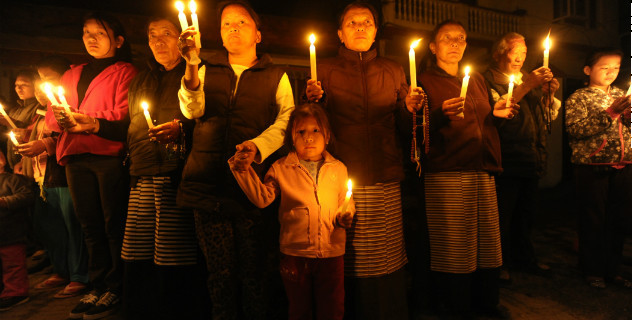 Tibetans-in-exile hold a candlelight vigil following the self-immolation attempt by a monk in Kathmandu on February 13, 2013/Getty 