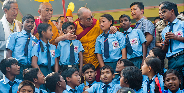 His Holiness the Dalai Lama greets students who performed on his arrival at the teaching ground in Salugara, West Bengal, on March 27, 2013. Photo/Tenzin Choejor/OHHDL 