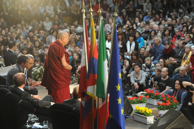 His Holiness the Dalai Lama during his talk "Happiness in a Troubled World" in Palatrento Stadium in Trento, Italy, on April 11, 2013