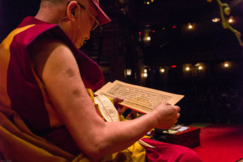 His Holiness the Dalai Lama reading from a Tibetan text during his teachings at the Beacon Theater in New York City, NY, USA on October 18, 2013. Photo/Robert Nickelsberg