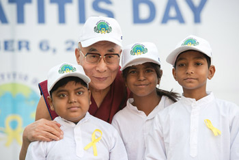 His Holiness the Dalai Lama with three young liver transplant patients who performed a song before his talk at the Institute of Liver and Billary Science in New Delhi, India on December 6, 2013. Photo/Tenzin Choejor/OHHDL