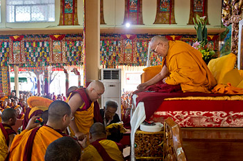 His Holiness the Dalai Lama accepting a mandala offering from H.E. Ling Choktrul Rinpoche on the first day of the Lam Rim teachings at Sera Monastery in Bylakuppe on December 25, 2013. Photo/Rio Helmi