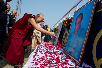 His Holiness the Dalai Lama offers floral tribute to the two founders of LBS before his talk at Nehru Stadium in Guwahati, Assam, India on February 2, 2014. Photo/Tenzin Choejor/OHHDL