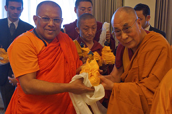His Holiness the Dalai Lama presenting a member of delegation of senior Sri Lankan monks with a Buddha statue after their meeting in New Delhi, India on March 19. 2015. Photo/Jeremy Russell/OHHDL