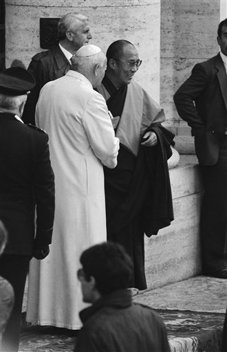 Pope John Paul II and the Dalai Lama shake hands as they met outside the basilica of Santa Maris degli Angeli where 200 representatives of 12 religions gathered for a World Day of Prayer for Peace in Assisi on Monday, Oct. 27, 1986. (AP Photo/Foggia)